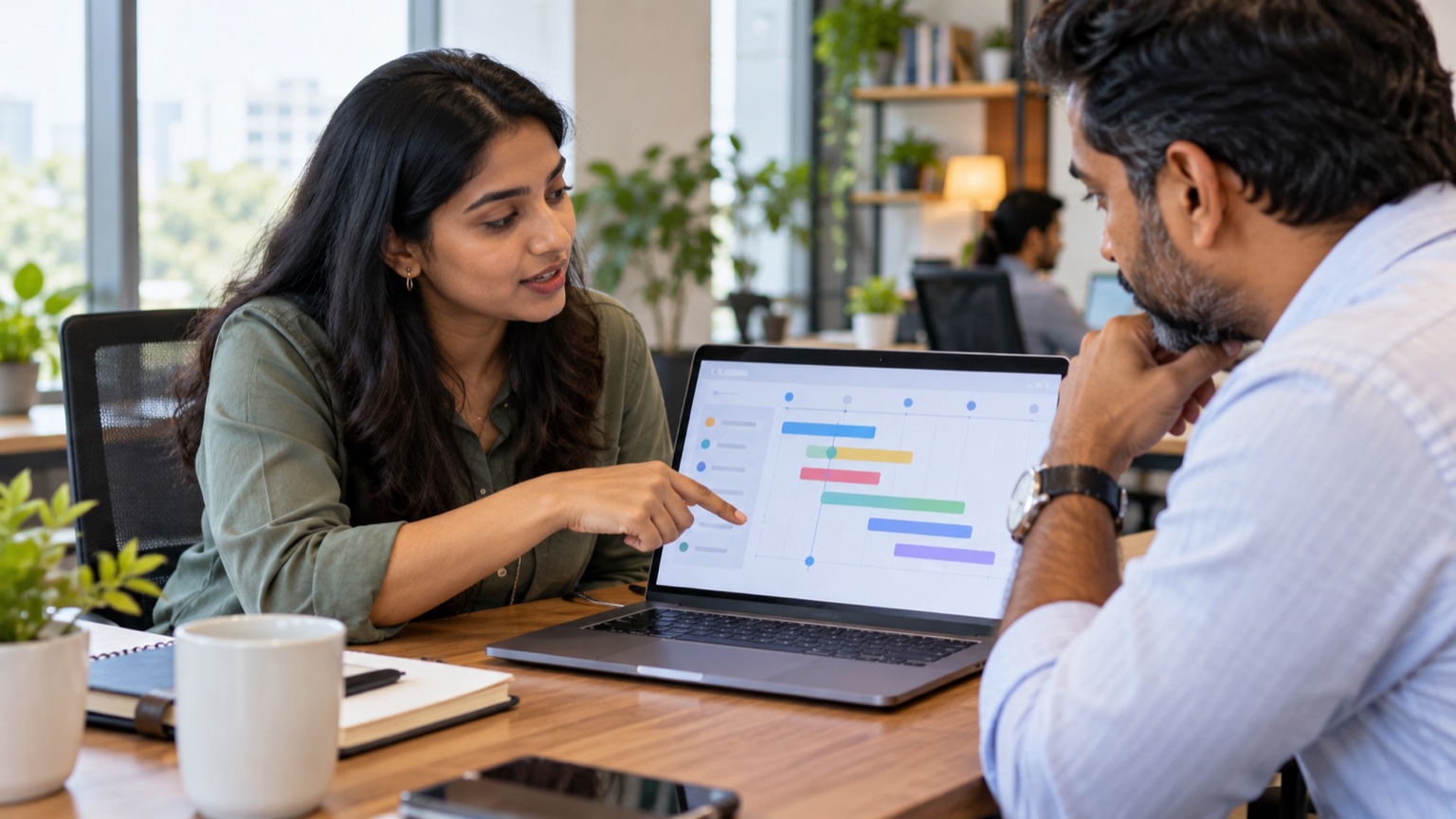 Indian marketing manager explaining an abstract campaign change timeline to a service-business owner